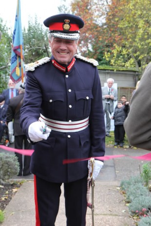 Lord Lieutenant Tim Cox cutting a ribbon.