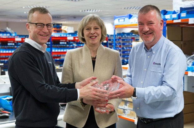 Theresa May presents the Queen's Award for Enterprise to Adrian Corbin and Mark Johnson.