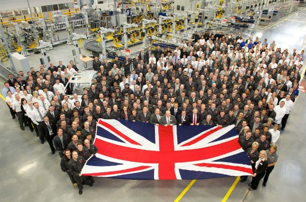 Workers at Jaguar Land Rover holding a Union Jack